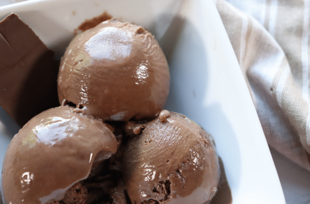 A bowl of creami triple fudge chocolate protein ice cream scooped into a bowl.