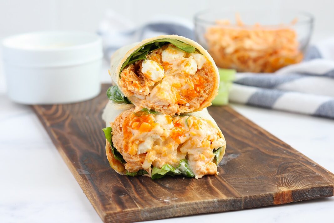 buffalo chicken wraps on a wooden serving board