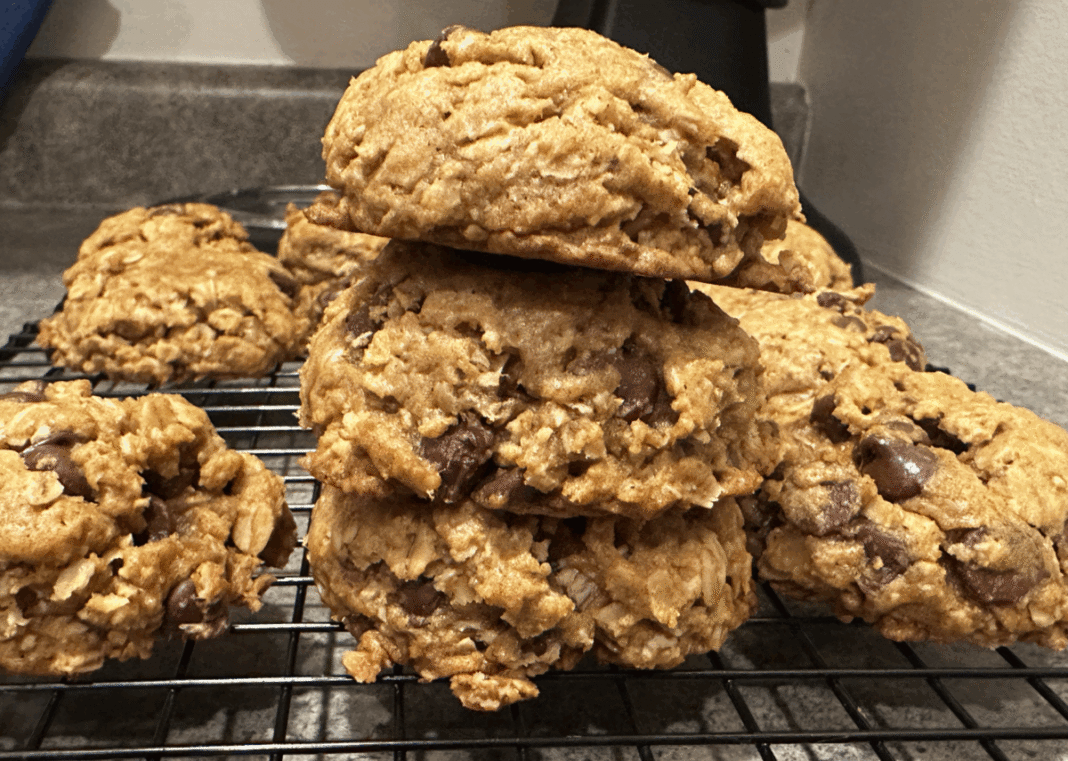 pumpkin oatmeal chocolate chip cookies stacked on a cooling rack.