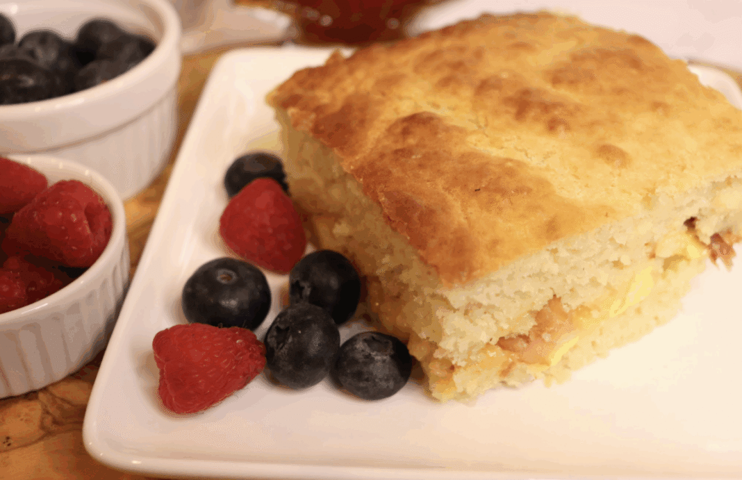 pancake casserole with eggs and sausage on a plate with fresh berries
