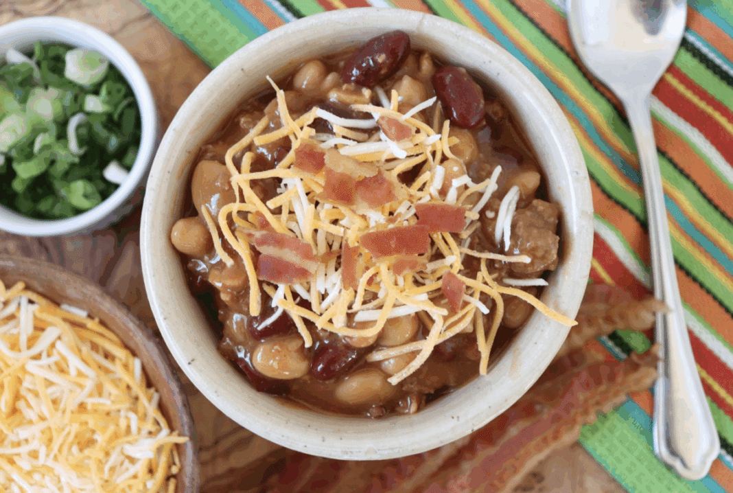 sweet chili in a serving bowl topped with shredded cheese and bacon bits